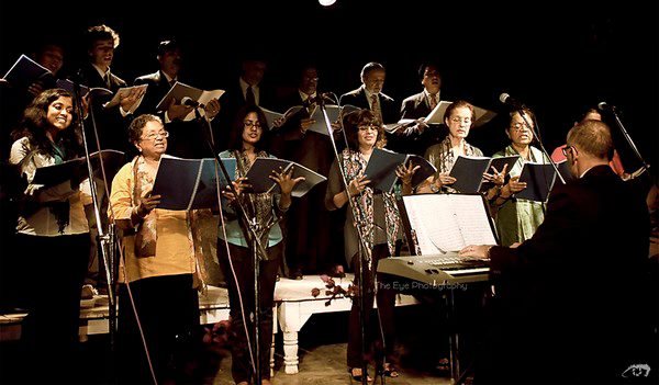 A choir singing with a pianist