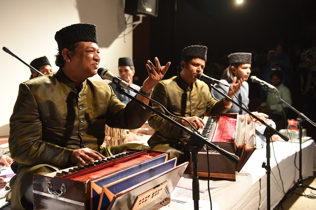 Qawwals in caps singing at harmoniums